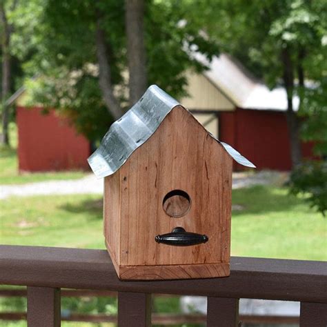 bird houses with metal roofs made of|metal house shaped bird feeder.